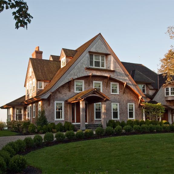 The front of a Watch Hill, RI shingle style home in early morning light.